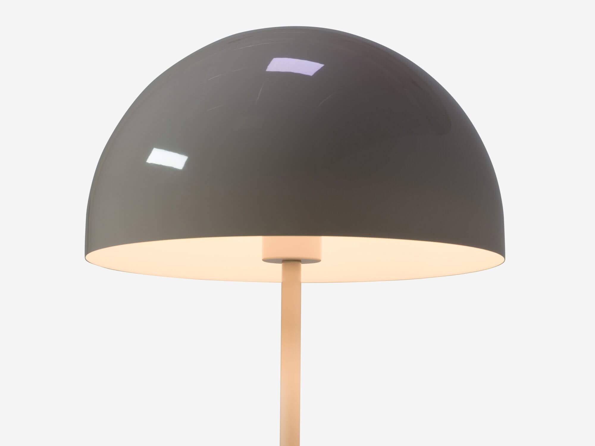 Detail view of round grey table lamp shade with light on